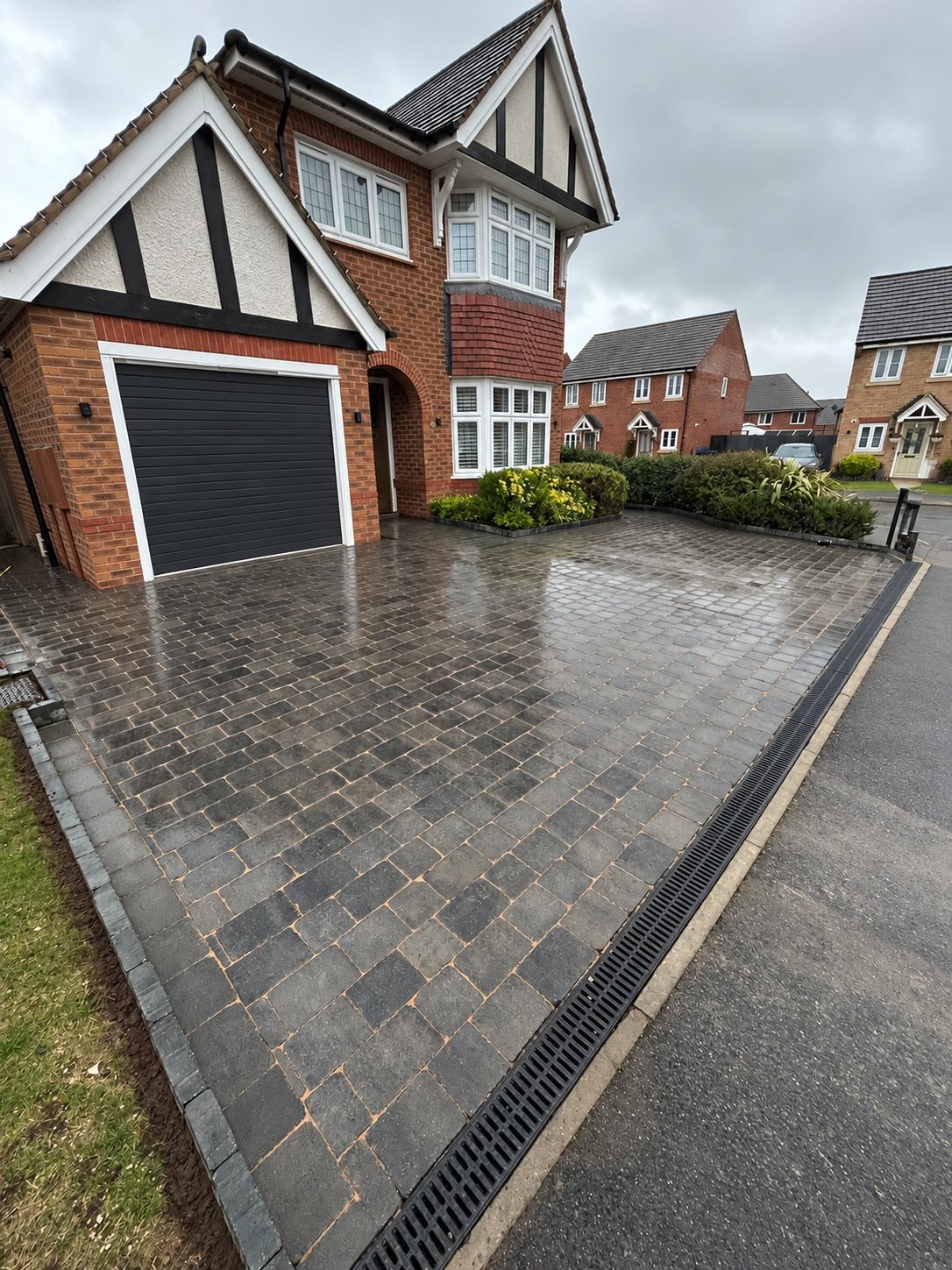 Block-paved driveway outside a red-brick home